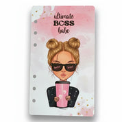 Notebook cover with illustration of a woman holding a pink drink, sunglasses with 'babe boss' text, and 'ultimate boss babe' text on a pink and white background.