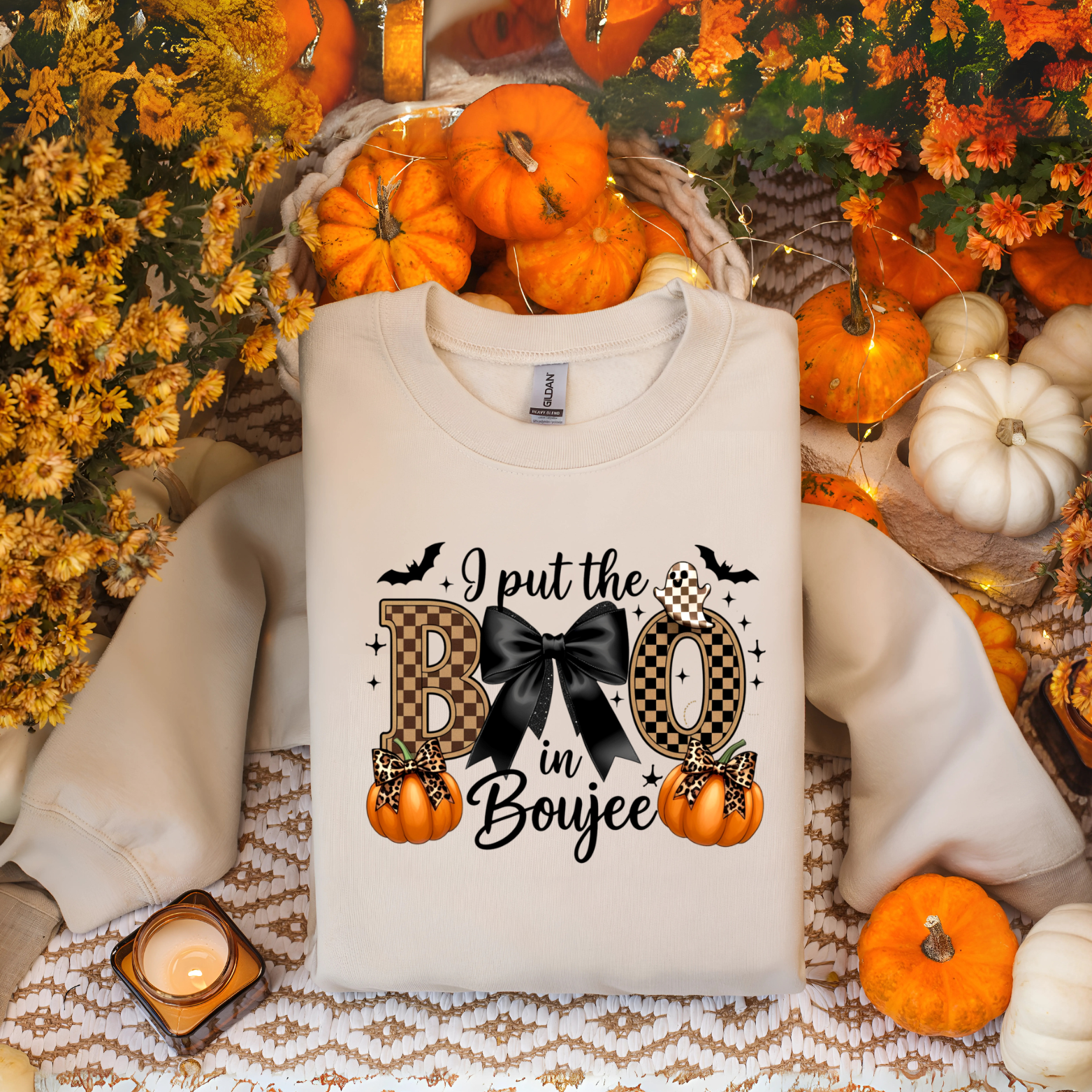 White sweatshirt with Halloween-themed design surrounded by pumpkins and fall decorations